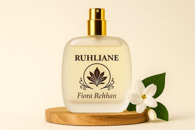 Ruhliane Fiora Rehhan perfume bottle with a white flower and green leaf on a beige background