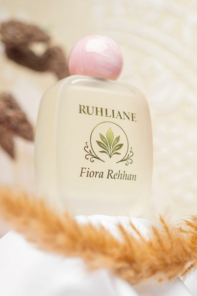 Ruhliane Fiora_Rehhan bottle with pink cap on a soft background
